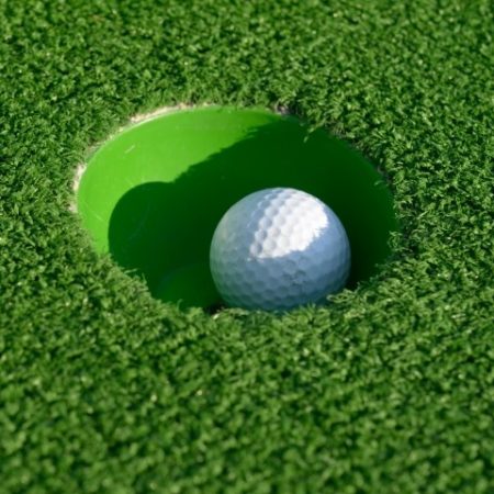 bigstock-Minigolf-ball-in-a-hole-closeu-39028573-450x450